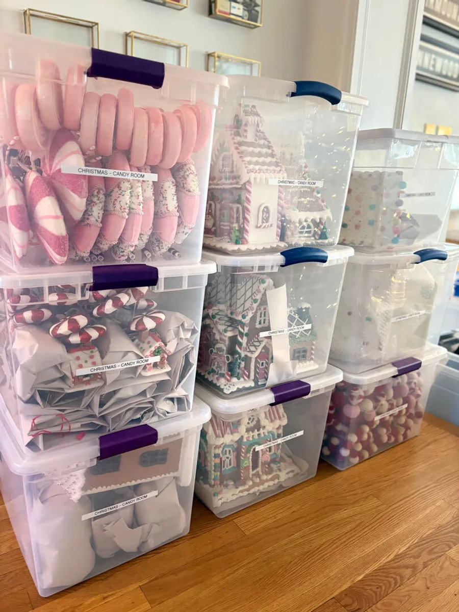 Clear storage totes of holiday decorations, labeled and stacked