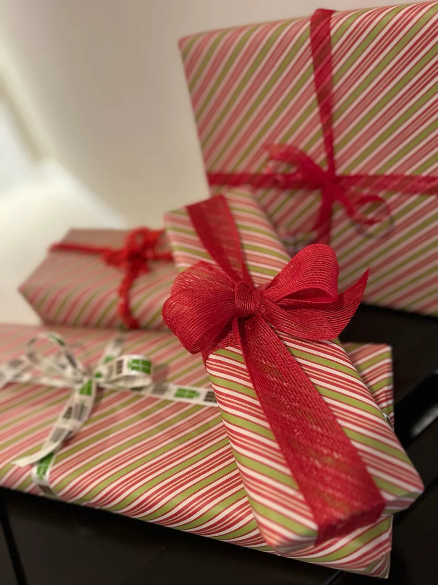 Gifts wrapped in red and white striped paper with red bows