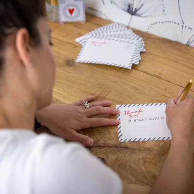 A team member writing a thank you note