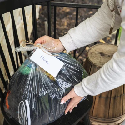 A bag of washed and folded laundry being delivered to a client's home