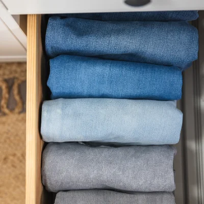 Neatly folded jeans in a drawer