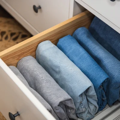 Neatly folded jeans in a drawer